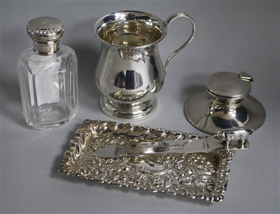 A George V silver capstan inkwell, a christening mug, a pin tray, a paper knife and a Watermans fountain pen paperknife